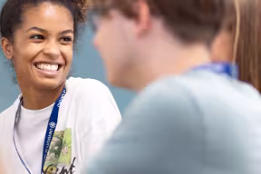Smiling student talking to friends