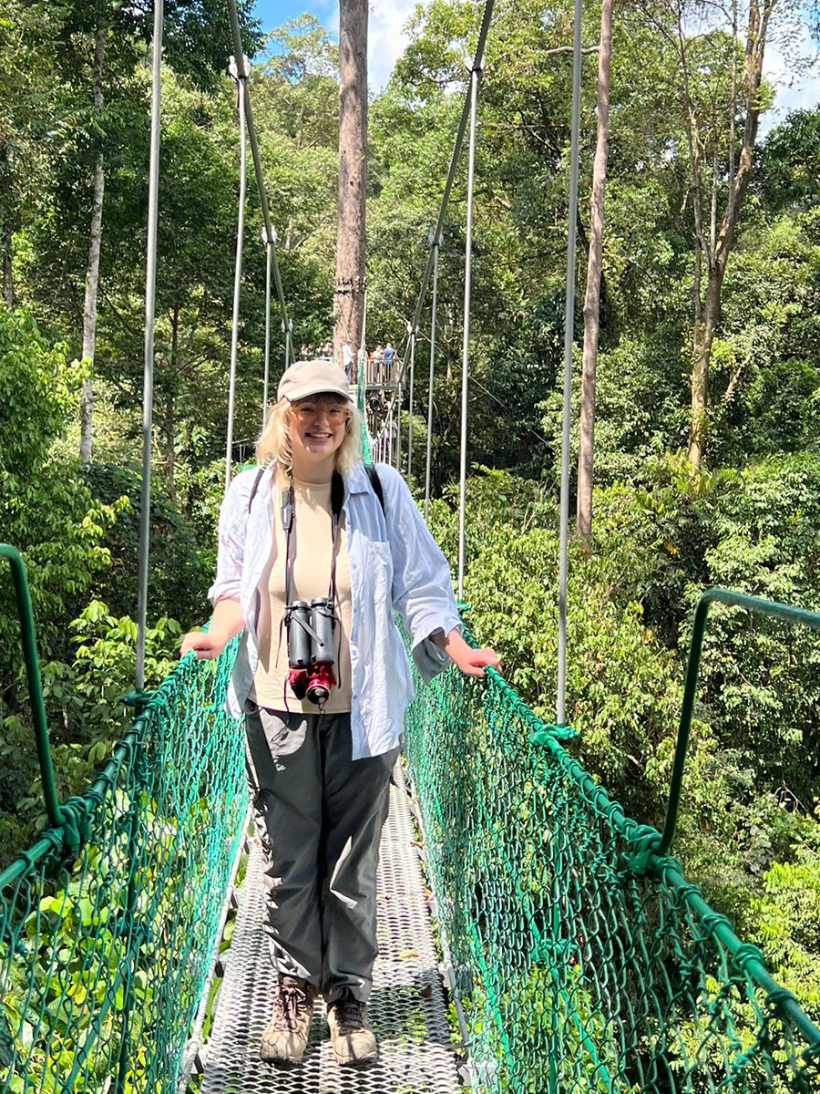 Oxford student on a walkway in a Borneo jungle