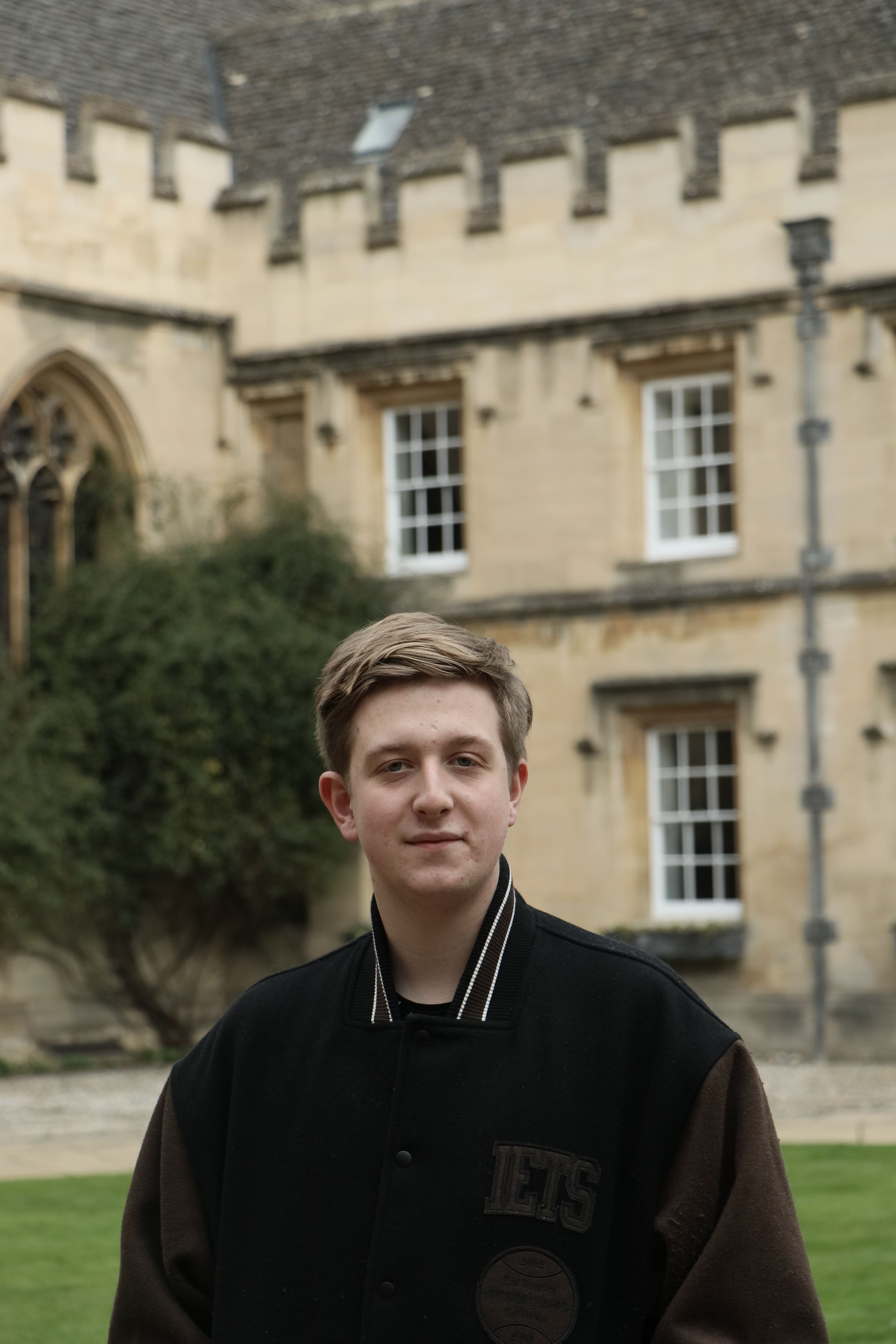 A St John's College Student standing in an Oxford Quad. 