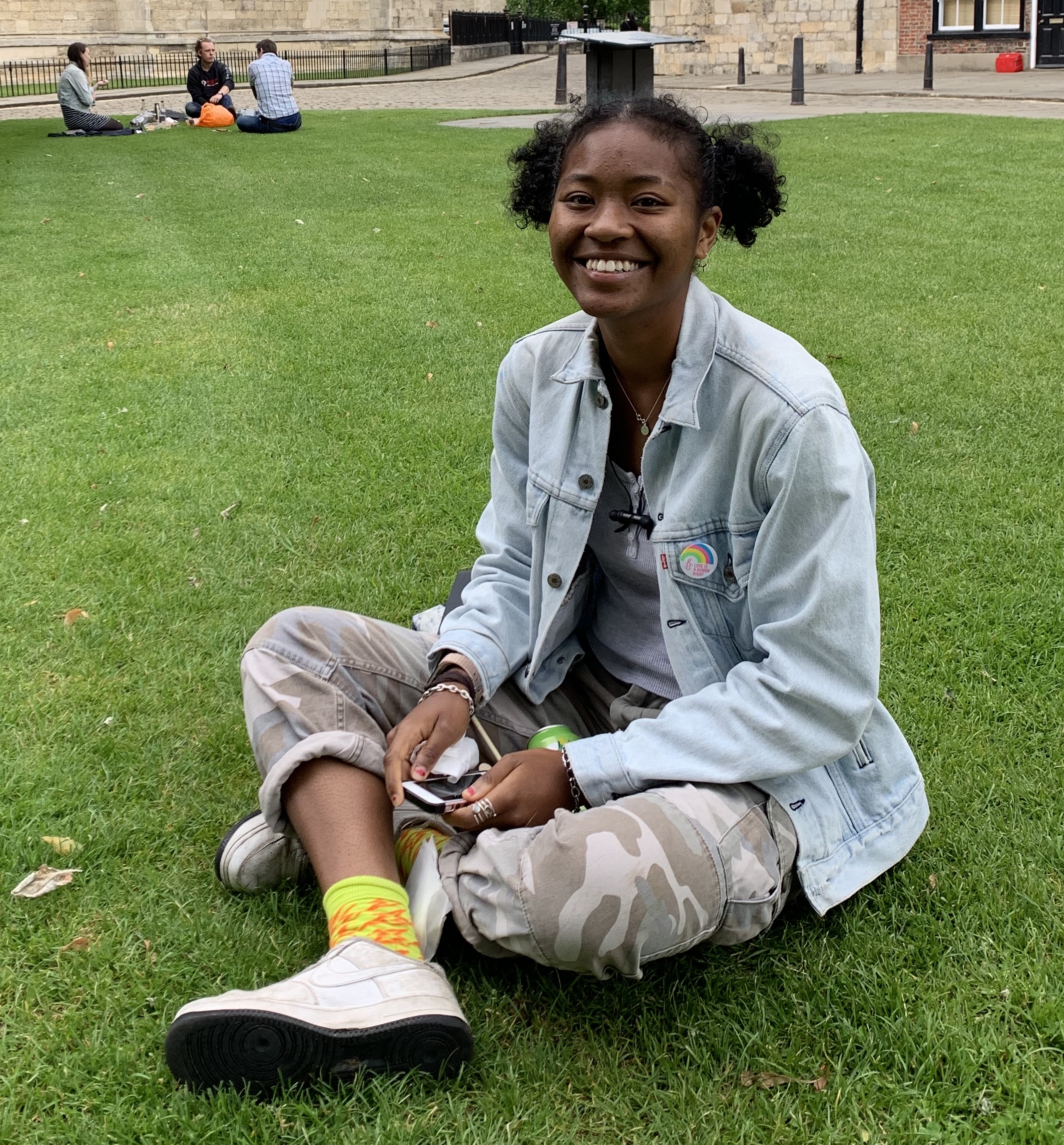 Student sat cross-legged on grass