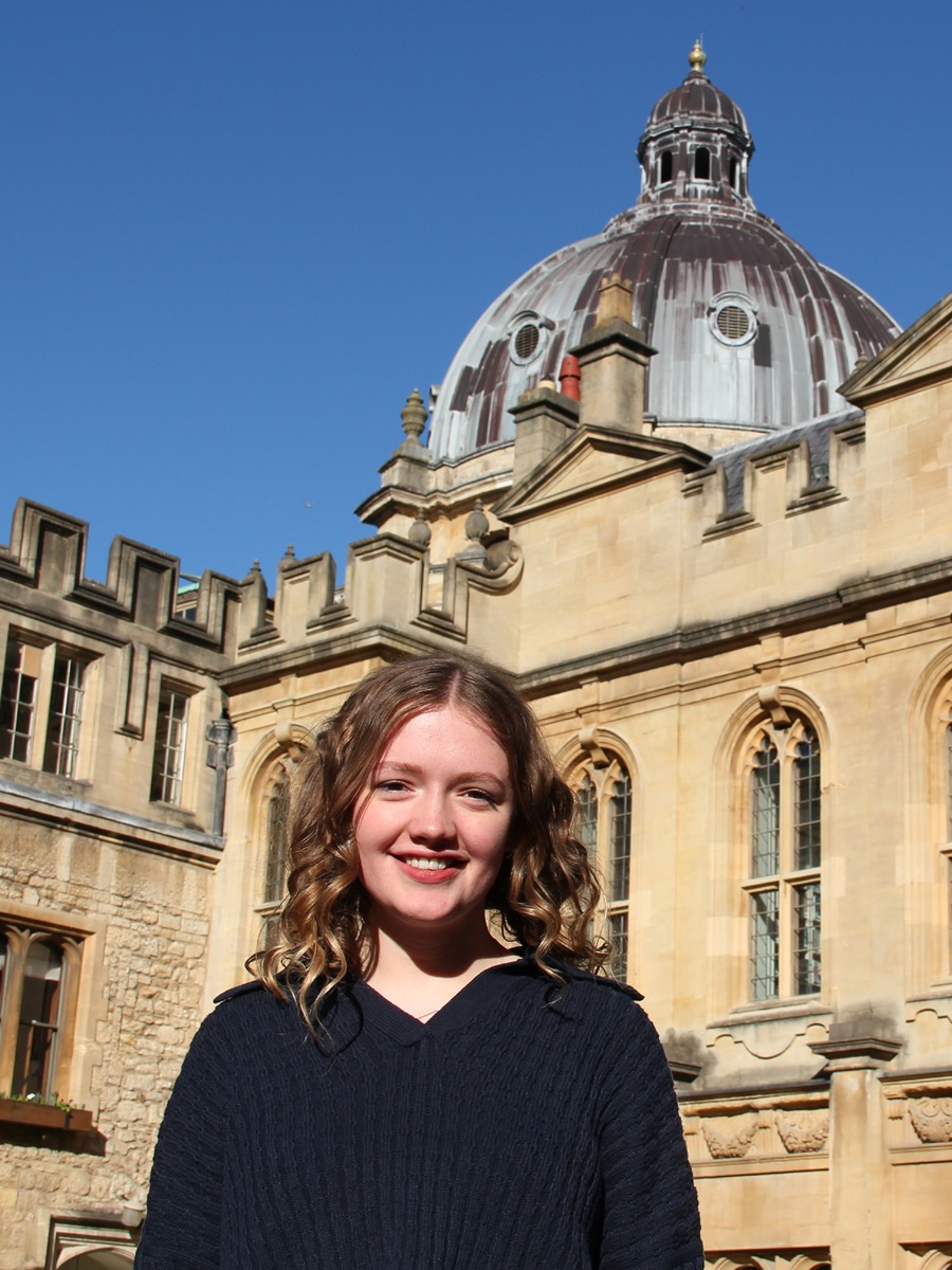 Oxford student in college quad with Radcliffe Camera in background