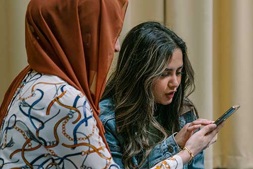 Two students looking at a phone together