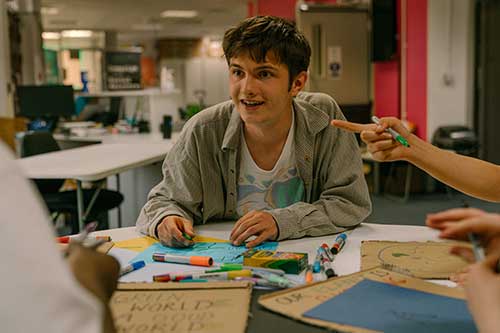 A student designing a campaign poster