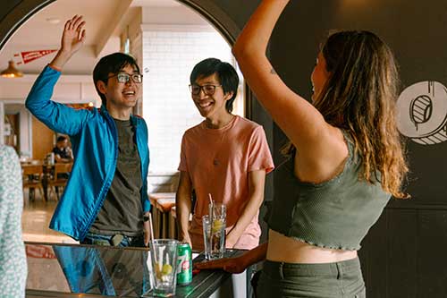 Students high-fiving as they play table football 