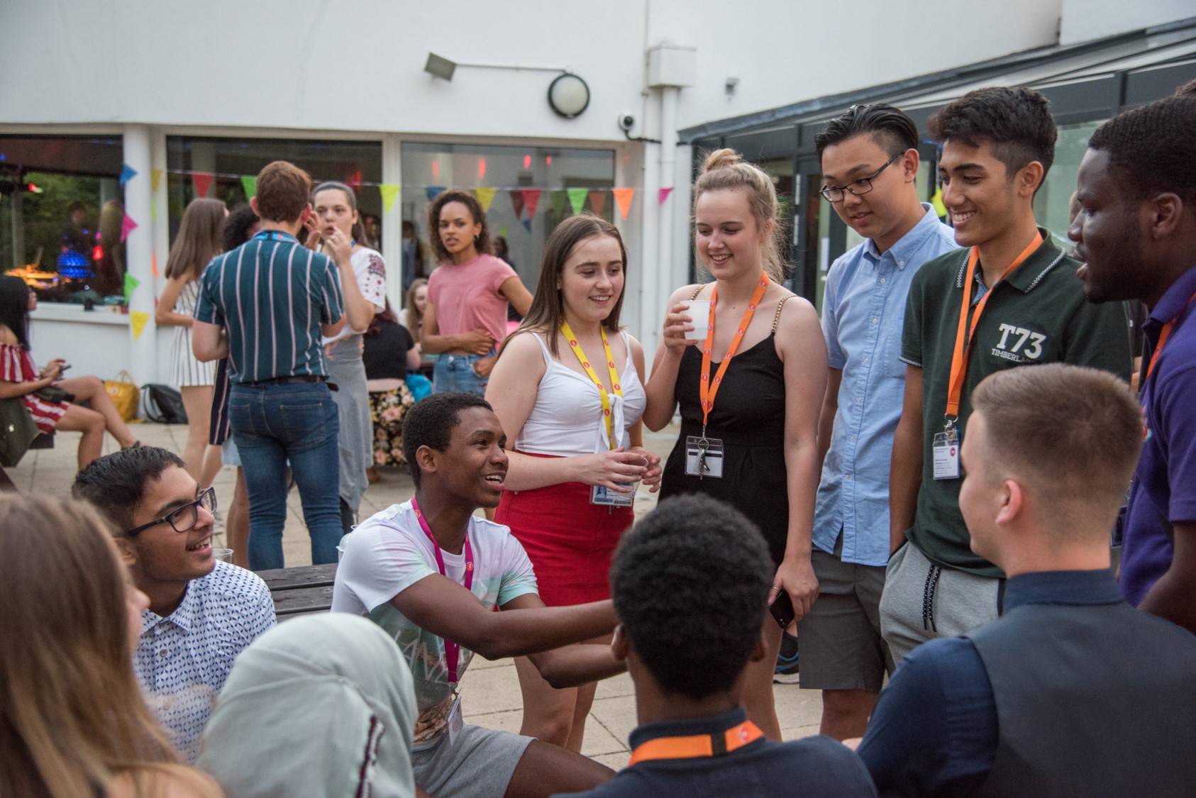 A large group of students wearing UNIQ lanyards at a UNIQ event