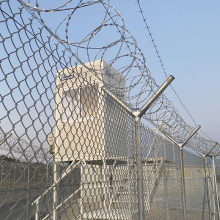 A watch tower overlooking a barbed wire fence