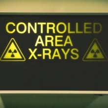 Illuminated sign in hospital warning about radiotherapy equipment in use