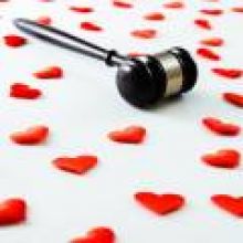 A gavel on a background of hearts