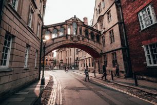 People walking under the Bridge of Sighs at sunset