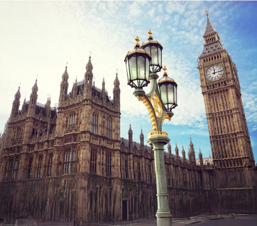 The Big Ben clocktower and the Houses of Parliament in London, with an ornate lamppost in the foreground. 