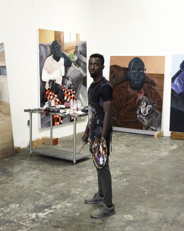 Image of Annan Affotey in his art studio painting