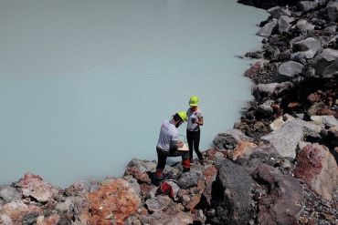 Donato Giovannelli and Karen Lloyd collect samples from the crater lake in Poás Volcano