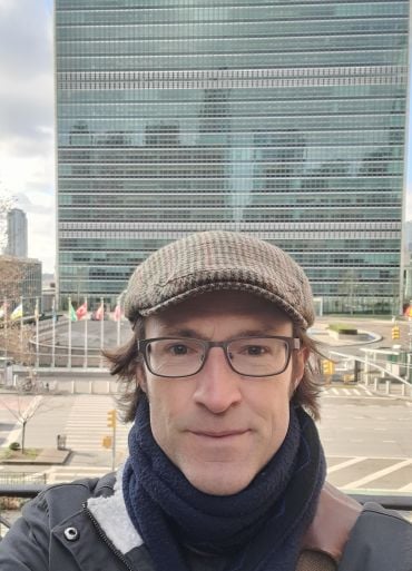 Professor Gledhill in front of the UN headquarters, New York, during a fieldwork research trip