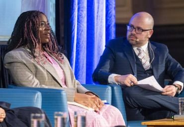 Image shows Dominique Palmer answering a question with Dr Julius Grower watching on