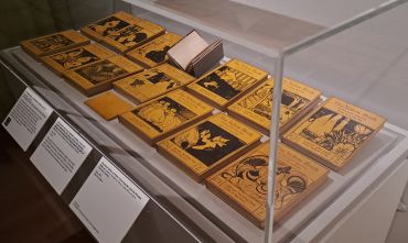 Image shows a display case at the exhibition including a collection of the The Yellow Book