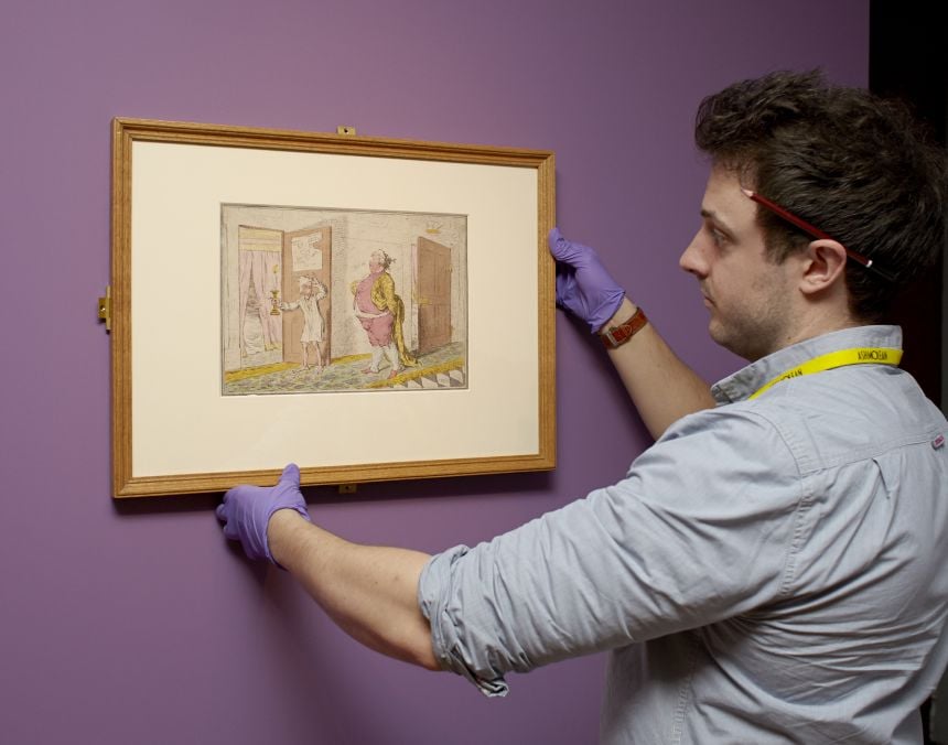 Ashmolean staff hanging a James Gillray caricature
