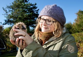 Head and shoulders image of Dr Sophie Lund Rasmussen holding a hedgehog for Find an Expert profile