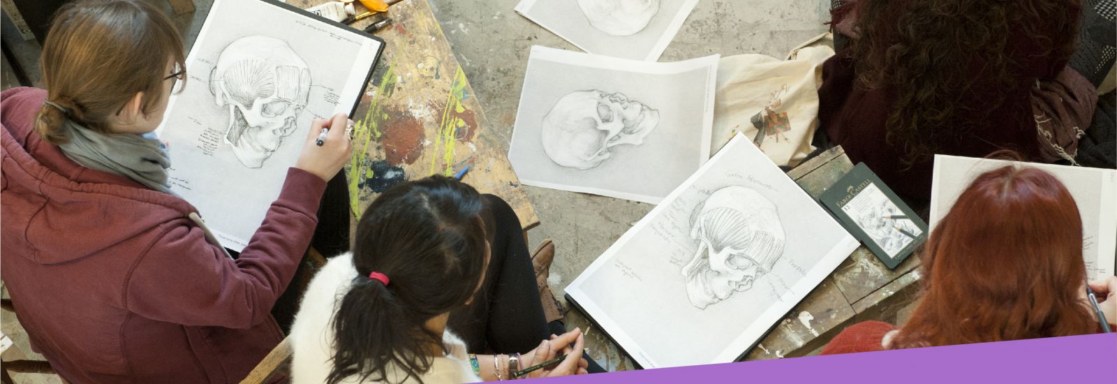 Fine art students sketching detailed skulls