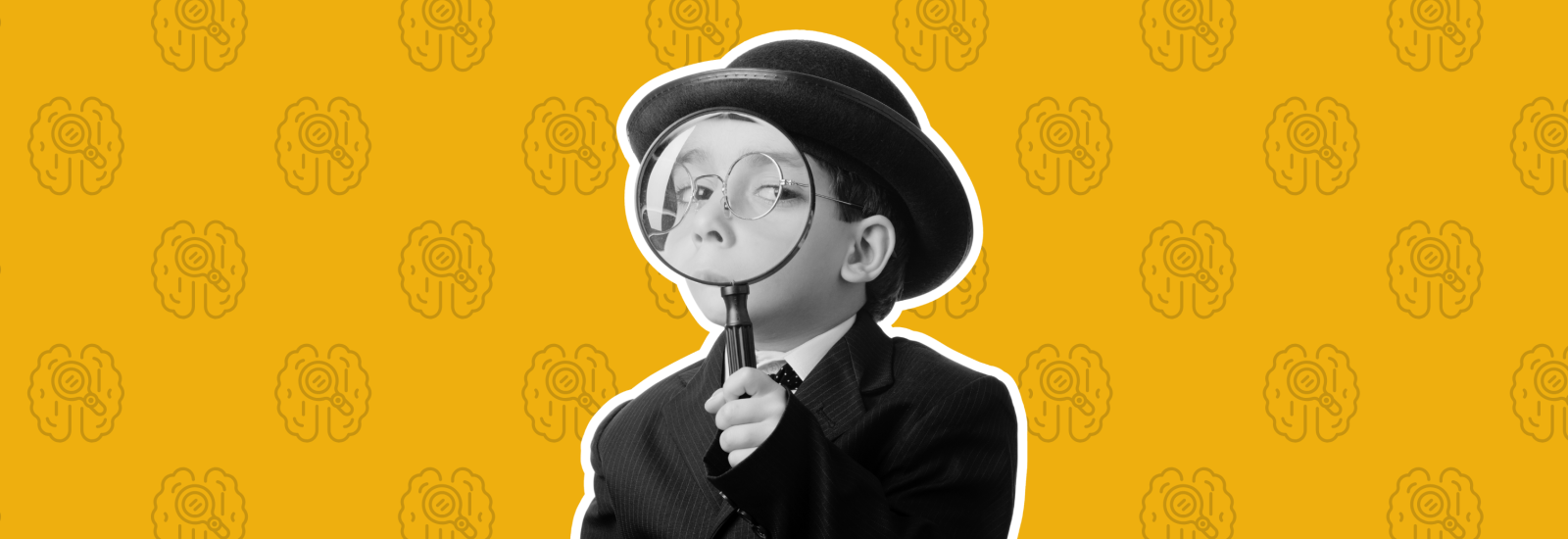 A young boy holding a magnifying glass.