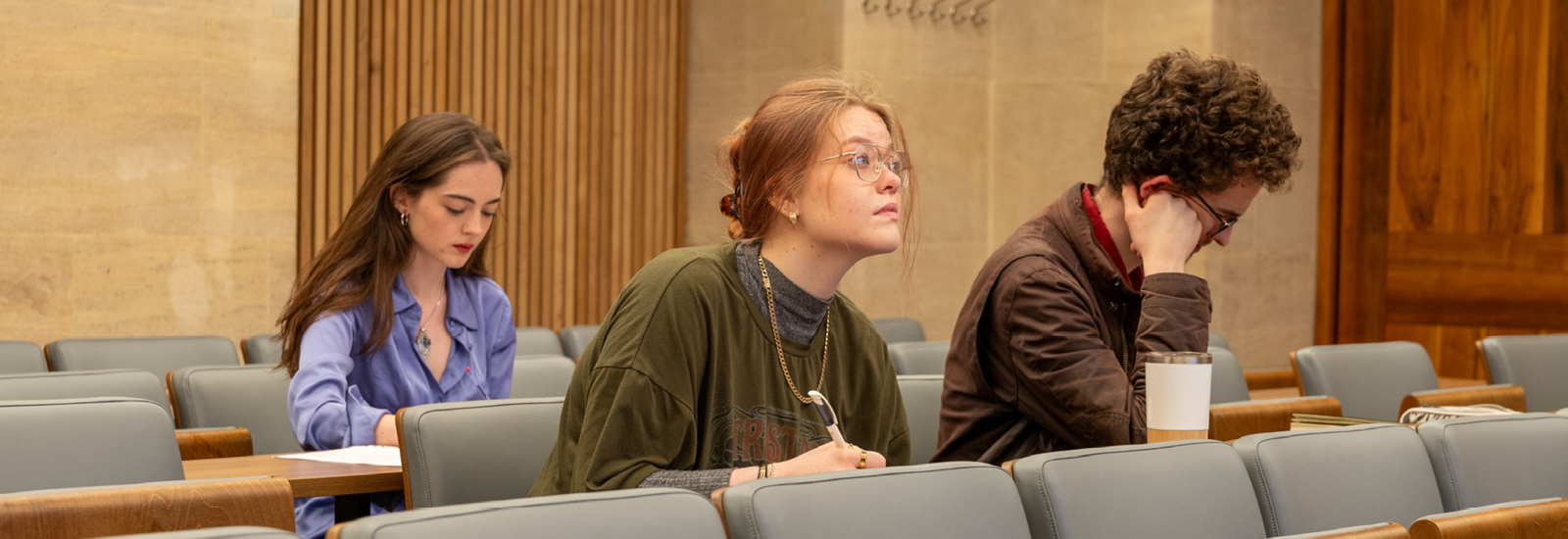 Students taking notes during a lecture