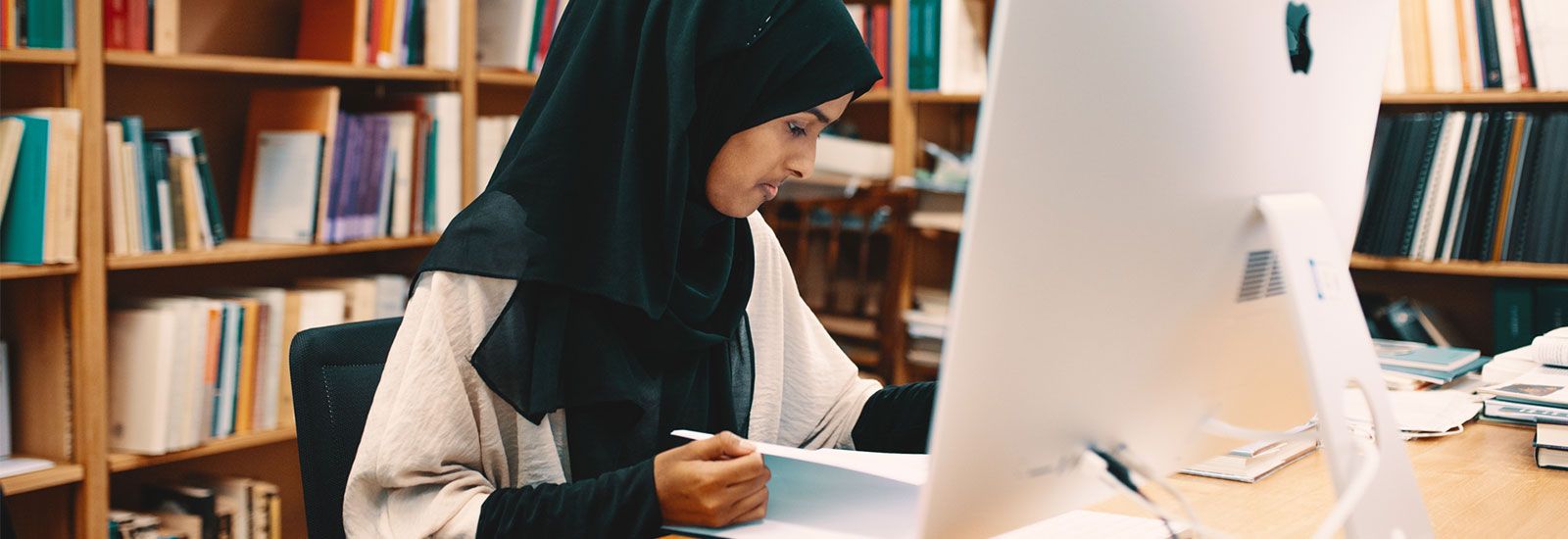 Woman student working in a library
