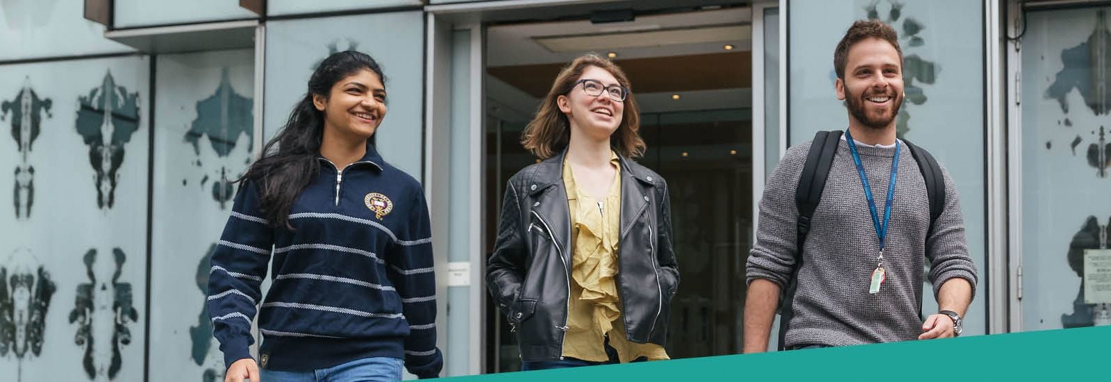Three students outside the Biochemistry Building