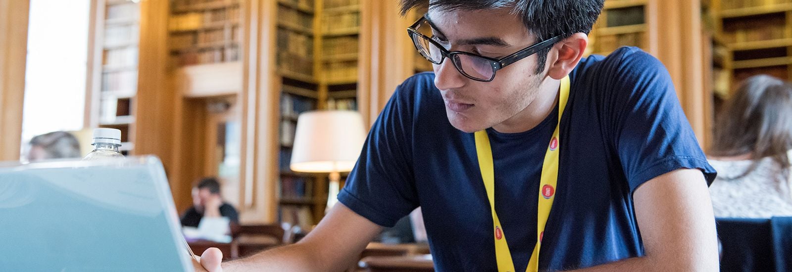 Male student wearing a UNIQ lanyard