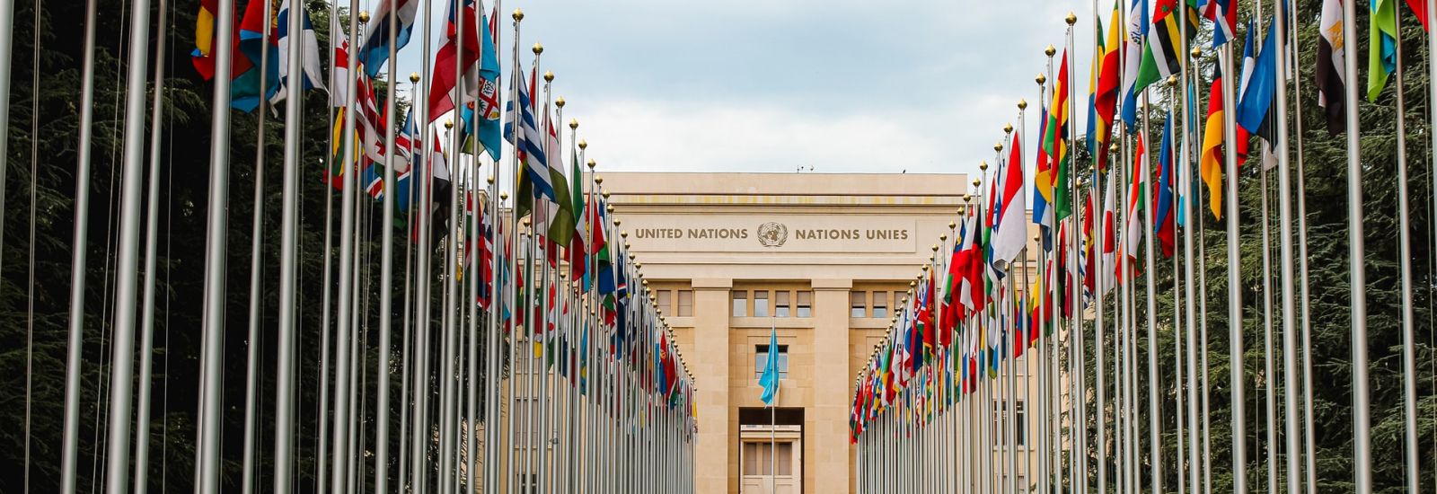 The United Nations office at Geneva, viewed through an avenue of flags of all the member states