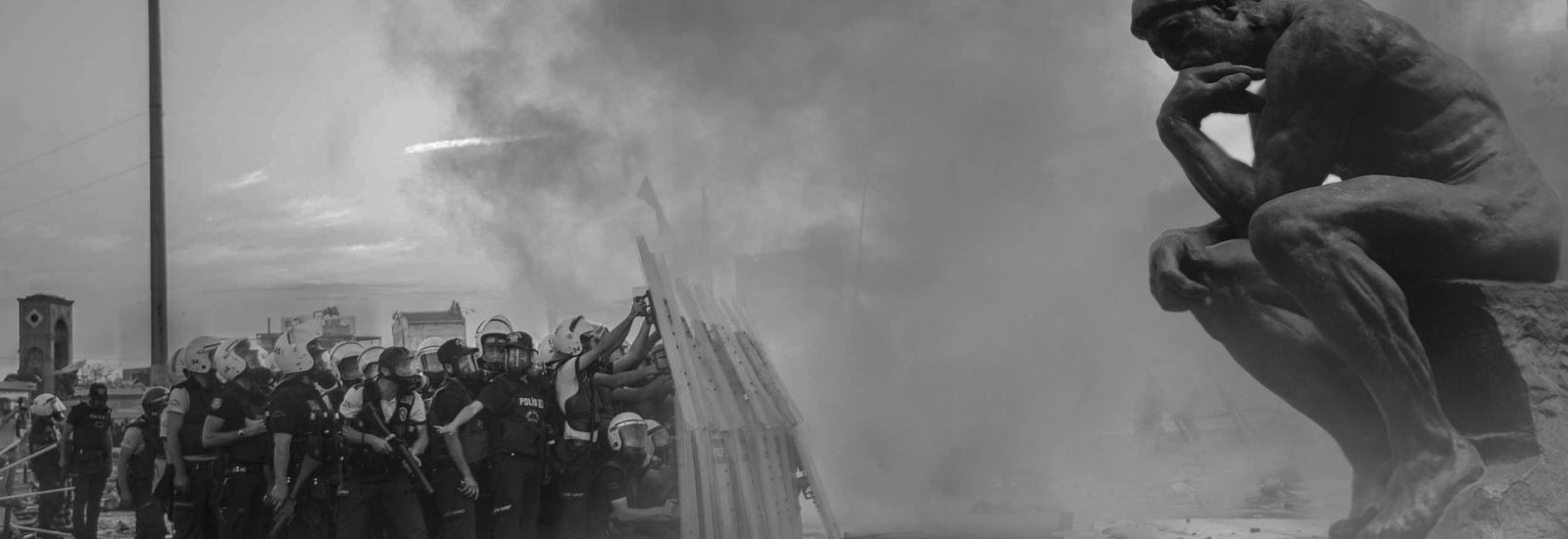 group of people in front of large statue surrounded by smoke