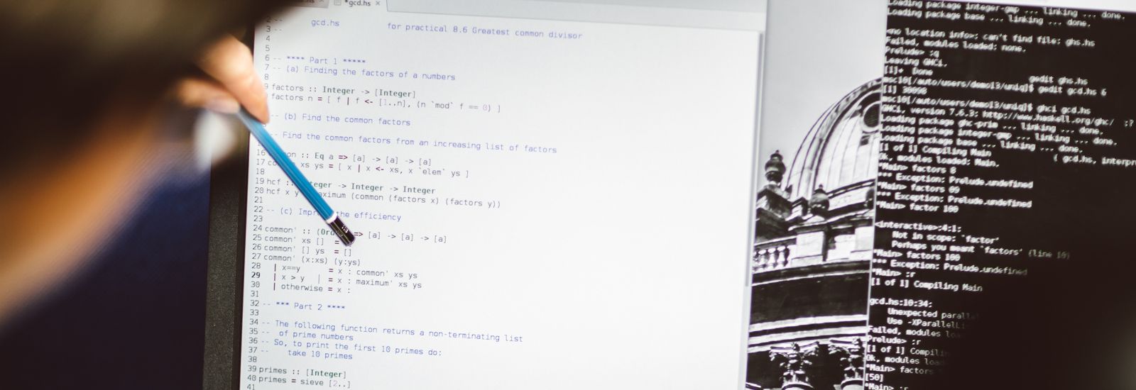 A pencil being pointed at a line of code on a laptop screen 