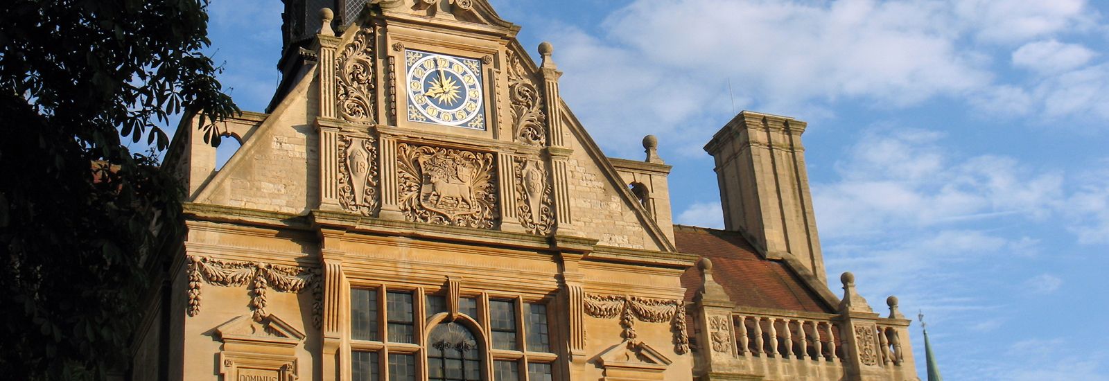 The History Faculty building with clock against a blue sky