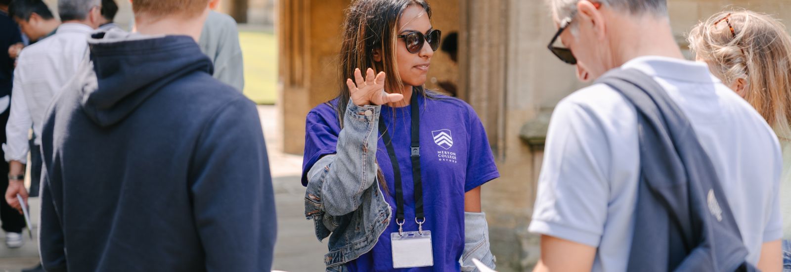An Oxford student ambassador giving directions at an Open Day