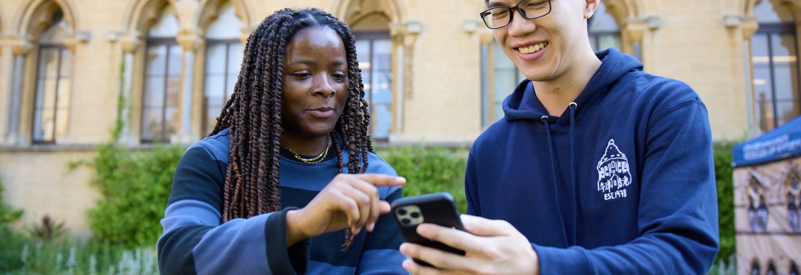 Two students looking at a phone
