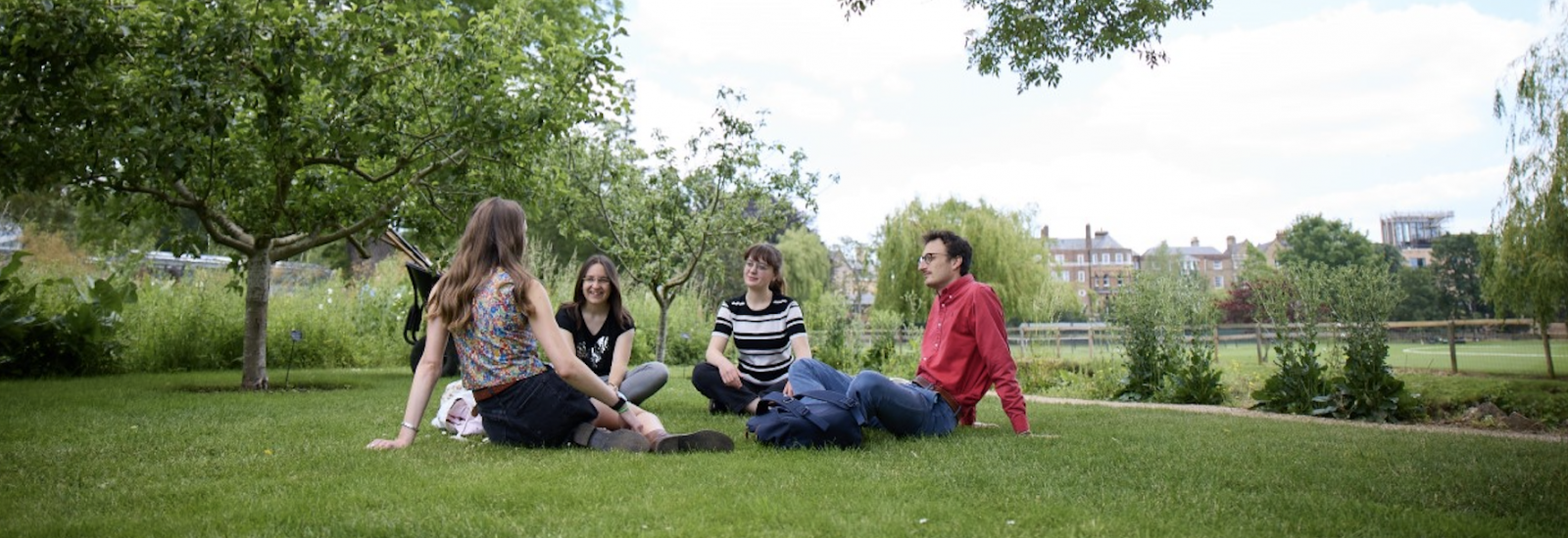 Students sitting outside on the grass. Credits: Ian Wallman, University of Oxford