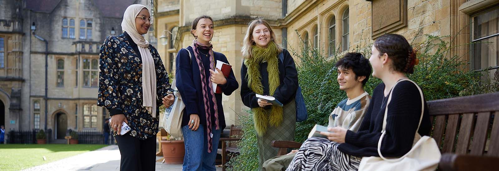 Photograph of a group of Oxford students gathered outside in the courtyard of Brasenose College