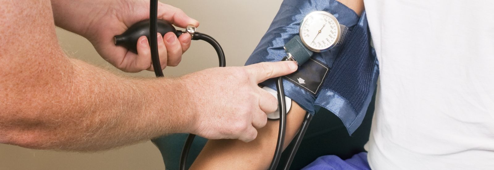 Man getting blood pressure tested by nurse