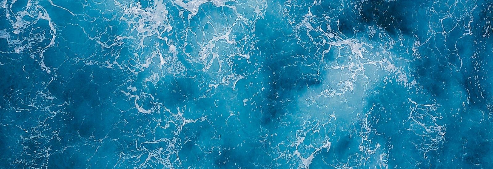 Aerial shot of blue water. 