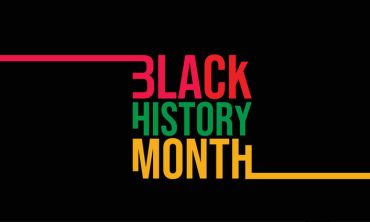 Red, green and yellow Black History Month words on a black background