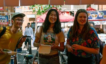 Three students at an Oxford food market