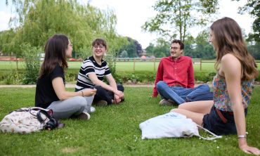 Students sat talking in the Botanic Gardens, Ian Wallman Photography. 