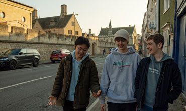 Three students walking along an Oxford street