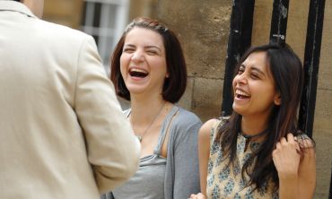 A group of three laughing postgraduate students