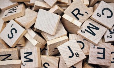 Wooden scrabble boards with letters. 