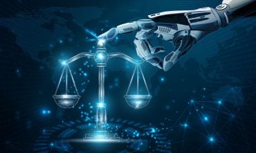 A robot hand touching the scales of justice