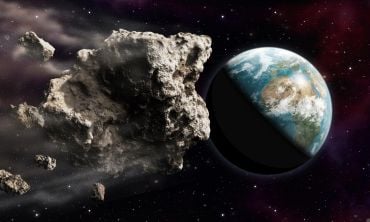 Illustration of a dangerously large asteroid approaching the Earth through outer space.