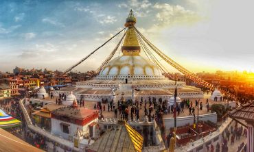 The dome-shaped Boudhanath Stupa monument in Nepal, with streamers flying from its steeple.