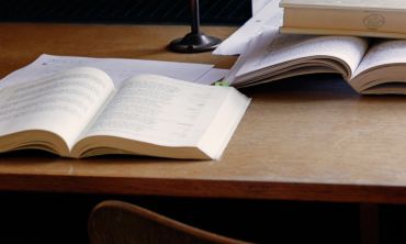 Open books on a wooden desk