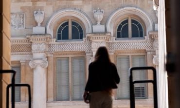 Silhouette of a student walking through an archway