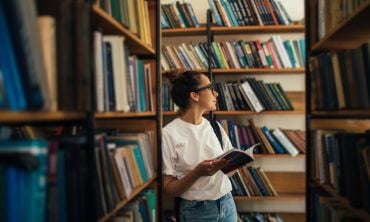 A student studying and reading books in a public library. Credit: Polina Lebed, Getty Images
