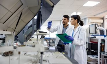 Team of scientists working at the laboratory processing samples. Credit: andresr, Getty Images  